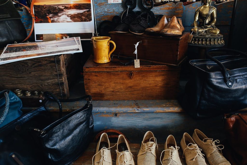 A charming display of vintage shoes, bags, and decor inside a rustic store setting.